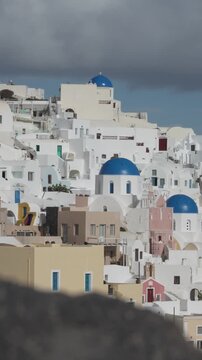 Two blue-domed Greek Orthodox churches in Oia (Apano Meria), Santorini, Greece