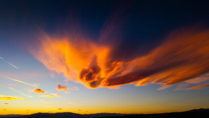 Not typical clouds during amazing colorful sunset sky