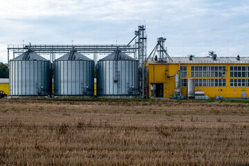 A large modern plant for the storage and processing of grain crops. Agro-processing manufacturing plant for processing drying cleaning and storage of agricultural products. Export of grain by railway