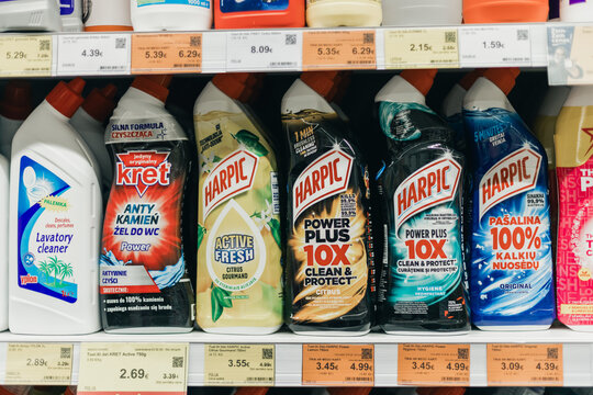 Valmiera, Latvia - February 23, 2026: Various cleaning products displayed on a supermarket shelf, including Harpic and Krete brands with visible pricing labels and colorful packaging