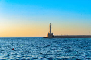 Fototapeta premium bay of Chania with sea and lighthouse at sunny summer sunset, Crete, Greece, web banner format
