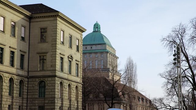 Panning shot of the iconic green dome of the ETH Zurich main building, showcasing neoclassical architecture of the Swiss Federal Institute of Technology in Zurich, Switzerland.