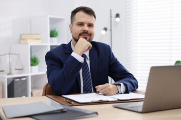 Portrait of notary at wooden desk in office