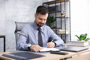 Notary working at wooden desk in office