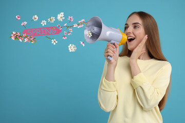 Hello Spring. Woman using loudspeaker on light blue background. Flowers flying out of device © New Africa