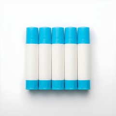 Fototapeta premium Glue Stick Set with Caps Aligned: Clean Classroom Supply Flat Lay, Minimal Craft Essentials for Teachers