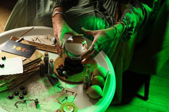 Fortune teller with crystal ball reading future  at table