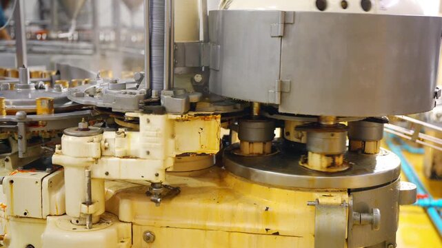 Automated canned seafood production line filling sauce into metal cans on conveyor belt in food processing factory, industrial packaging system and mass production workflow in manufacturing facility