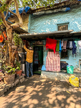 Man Hanging Laundry Indian Blue Painted Village House