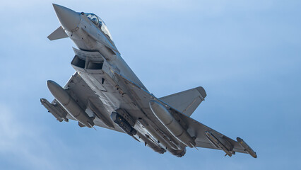 fighter jet flying overhead at close altitude