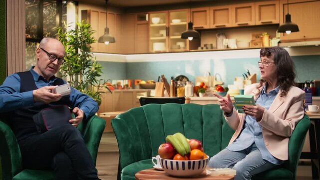 Aged woman checking prescribed pills box and man preparing BP monitor, senior couple with daily healthcare on couch. In-home healthcare, disease management and routine supports longevity.
