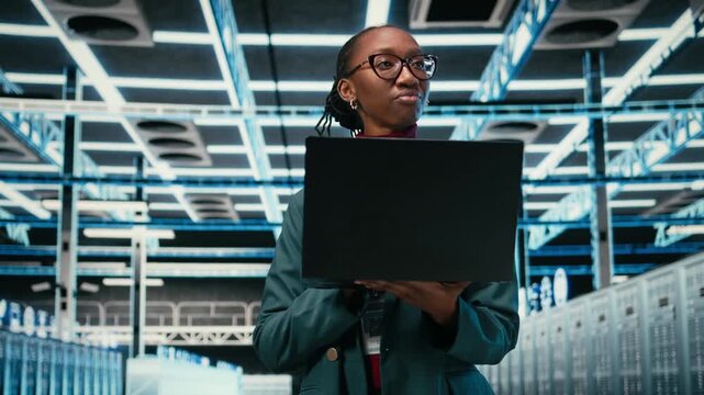 Monitoring systems, laptop and female programmer walking in AR simulation data center. Optimizing, VFX compositing and African american woman in server hub using notebook, camera A