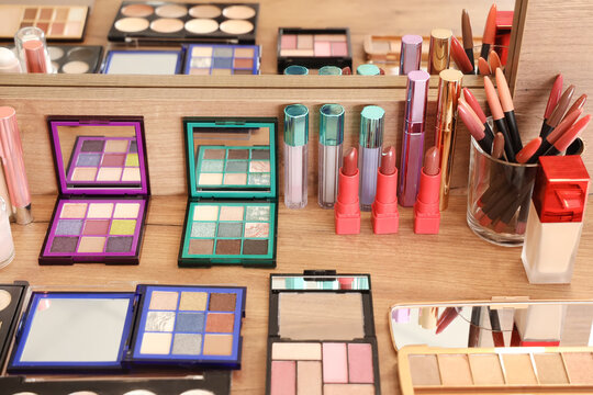 Various decorative cosmetics on makeup artist's table in studio, closeup