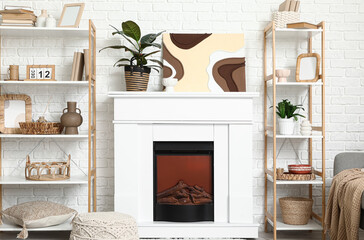 Fototapeta premium Interior of modern living room with fireplace and home decor in shelving unit