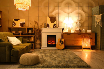 Fototapeta premium Interior of cozy living room with fireplace, guitar and green sofa in evening