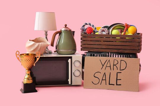 Unwanted stuff for yard sale on pink background