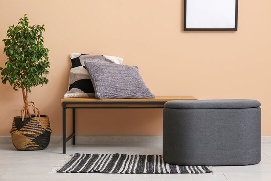 Pouf and bench with pillows in living room