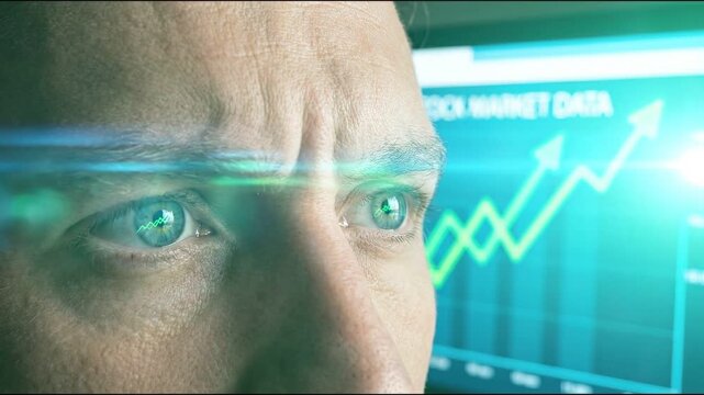 Intense businessman with focused green eye analyzes business growth chart on computer monitor, viewing market data indicating success