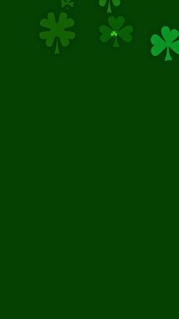 St Patricks day background with cartoon shamrocks in various greens. Three and four leaf clover particles floating downward for a green background to celebrate St Patrick day.