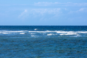 Landscape of a calm ocean and blue sky. Summer tropical turquoise sea.
