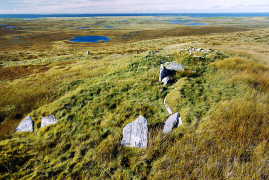 South Clettraval Chambered Cairn prehistoric tomb in foreground on S slope of South Clettraval, N. Uist. View to WSW over adjacent wheelhouse behind