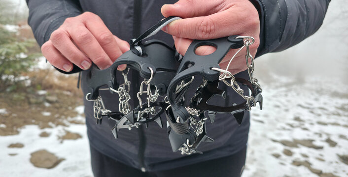 Crampons for shoes for walking on icy surfaces and winter mountain trips. Essential equipment for safe hiking on icy trails.