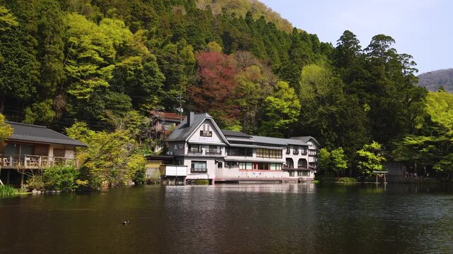Kinrin lake in Yufuin town, Kinrin-ko lake, Oita prefecture, Japan, hot spring onsen resort town, with mount Yufu, Kyushu island region, rural mountain landscape, a spring day with a blue sky