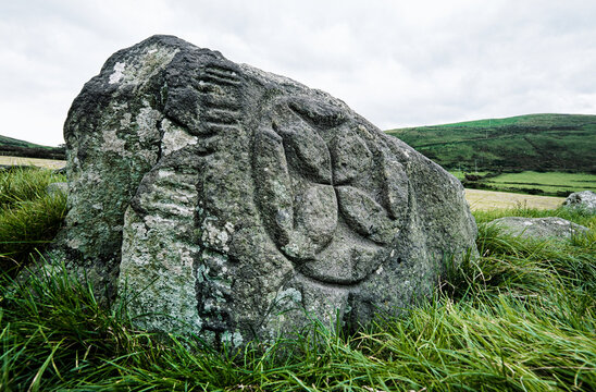Kilcolman mediaeval monastery site. Dingle, Kerry, Ireland. The Christian Celtic cross and Ogham script inscribed stone. Cross pattee, cross patty