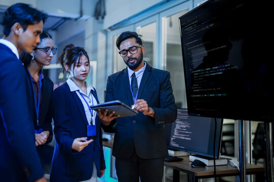 Artificial intelligence research team evaluating neural network algorithm efficiency. Lead data scientist explaining predictive machine learning model to corporate analysts.