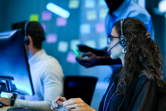 Corporate workforce professional managing business operations in modern tech office. Female call center agent adhering to operational compliance protocols.