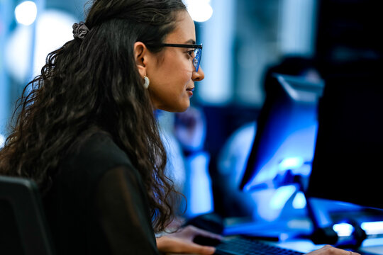 Senior software engineer debugging backend architecture code during agile sprint. Female developer reviewing syntax optimization strategy on digital screen.