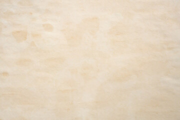 Obraz premium Old vintage paper texture background with aged stains and antique yellowed parchment effect