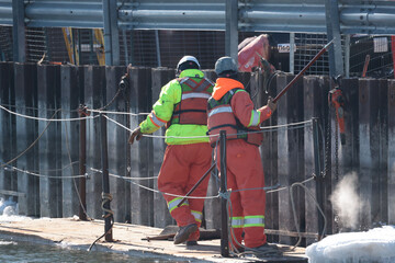Workers and trucks and factory at a Uranium Processing plant.  © Janet