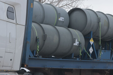 Workers and trucks and factory at a Uranium Processing plant.  © Janet