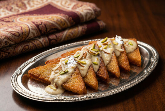 Shahi Tukda Indian dessert made of fried bread topped with thickened sweetened milk and nuts