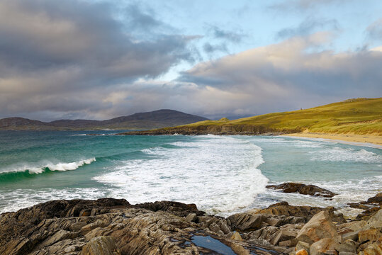Nisabost Beach, Harris, Outer Hebrides. Neolithic standing stone MacLeods Stone on horizon centre right marks Neolithic through to Norse enclosures