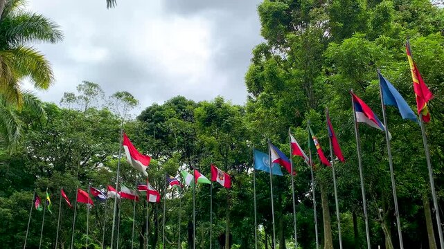 The Indonesian flag or red and white flag is surrounded by flags from various countries fluttering in the wind.