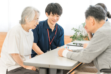 Obraz premium Seniors and occupational therapists using cylinder pegs for hand and finger function training during rehabilitation