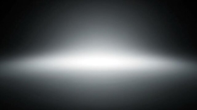 A spotlight shines brightly on a dark stage from a high angle viewpoint