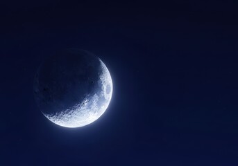Waxing crescent celestial body glows brightly against deep indigo night sky backdrop