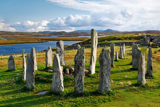 Tursachan prehistoric stones at Callanish, isle of Lewis, Scotland. aka Callanish I. Centre monolith, circle stones and chambered tomb looking S. East