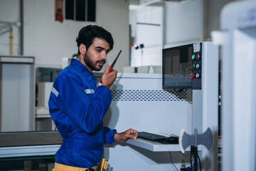 Professional Woodworker Measuring, Cutting and Installing Timber in Factory. Carpentry and Wood Manufacturing Process in Industrial Workshop