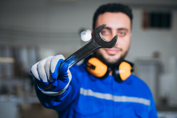Portrait of Professional Carpenter Working in Industrial Workshop. Skilled Carpenter Standing in...