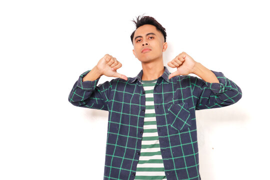 Arrogant young Asian man standing and pointing at himself with a proud expression on white background. Self-confident and ego concept