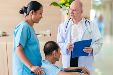 Obraz premium Medical Team Assisting Male Patient in Wheelchair