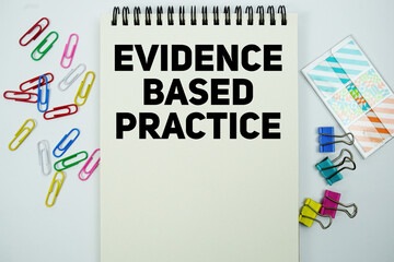 Evidence Based Practice text message written on notepad with stationery flat lay on white background