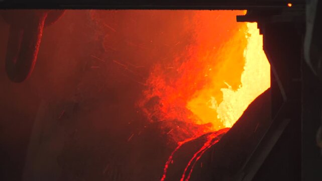 Closeup Of Industrial Casting Process With Bright Molten Steel Cascading And Sparks Flying Rapidly . Stock clip