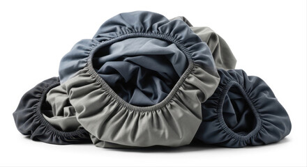 Rolled fitted sheets in various grey tones isolated on a white background, showcasing elastic edges and smooth fabric in a neat arrangement