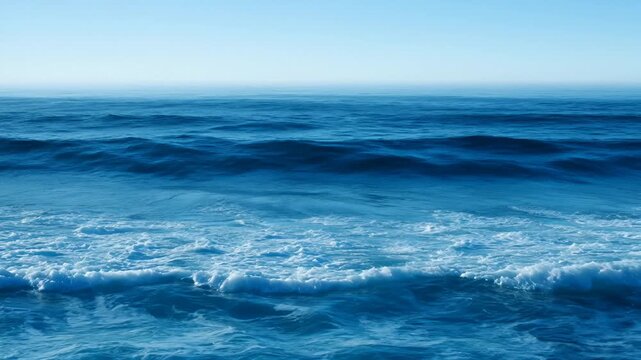 Ocean Wave Breaking With White Foam and Blue Water Under Clear Sky