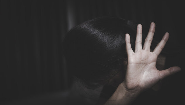 stop violence against Women. A woman holds up her hand in a stop gesture, looking distressed, symbolizing the fight against violence and abuse. ,sexual abuse, human trafficking